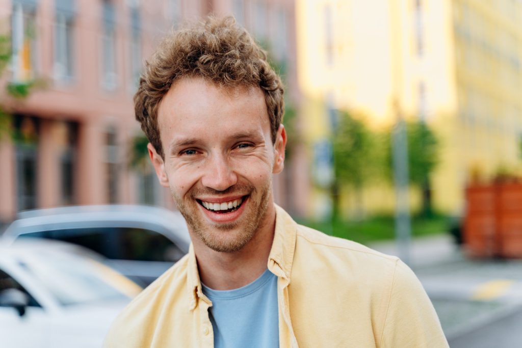 Handsome young man on the background of the city.